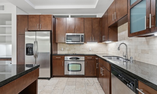 kitchen with ample counter-space, modern appliances and bright lighting
